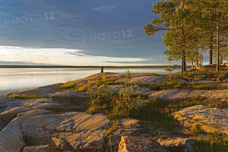 Evening on the White Sea. Stone pillar on coastal granite rock. Kandalaksha Gulf, Karelia, Russia, end of June, Europe