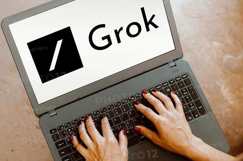 In this photo illustration, the xAI Grok logo is displayed on a notebook screen