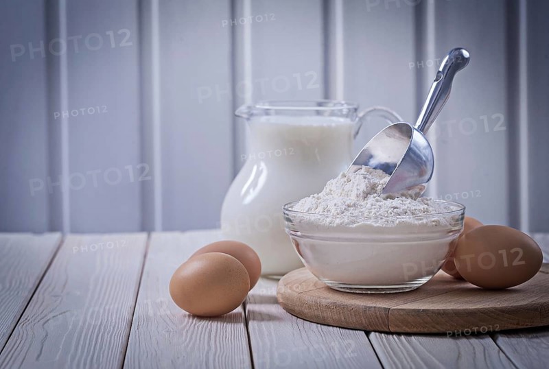Eggs piala with flour and milk in jug