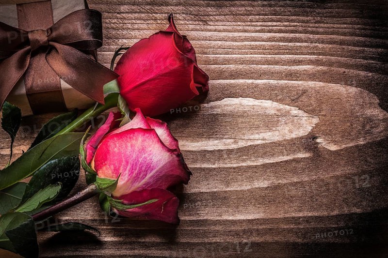 Red roses giftbox on wooden board holidays concept