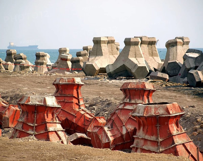 Large concrete tetrapods are placed on the sea shore