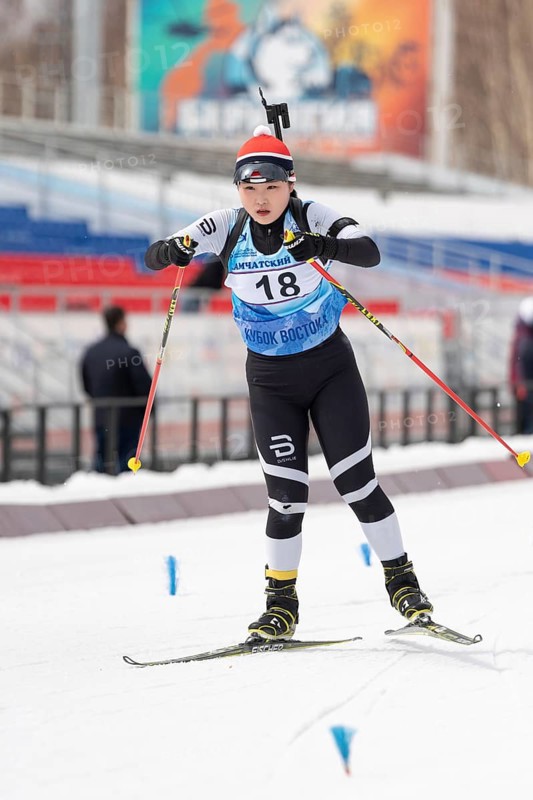 Korean sportswoman biathlete Choi Yoonah skiing on distance biathlon stadium during Open regional youth biathlon competitions East Cup. Kamchatka Peninsula, Russian Far East, April 12, 2019