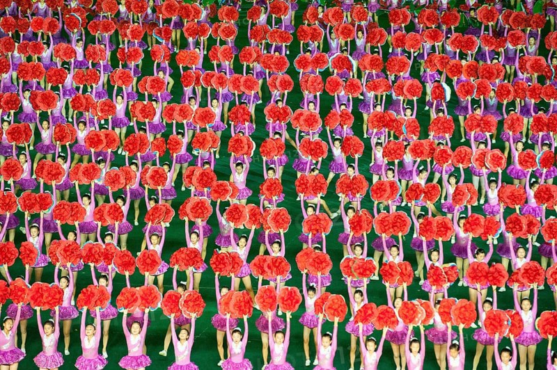 08.08.2012, Pyongyang, North Korea, Asia, Dancers and acrobats at the Arirang Festival at the Rungrado May Day Stadium in Pyongyang. The majority of the performances during the mass event are performed by dancers from the field of rhythmic gymnastics, who have been trained and rehearsed for months in advance. An estimated 100, 000 dancers, acrobats and participants celebrate their patriotism and the socialist unity of the Juche ideology. The event takes place every year in the warm summer months from July to September, Asia