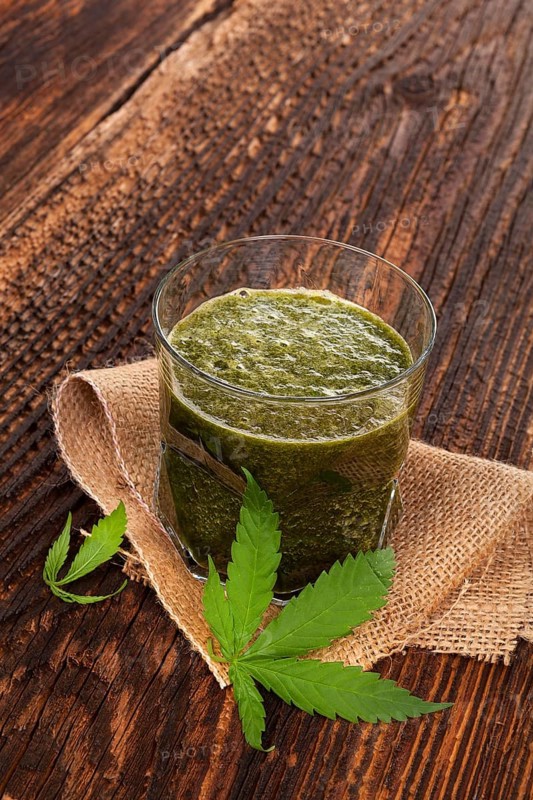 Healthy cannabis smoothie on wooden background. Natural supplement, detox and healthy living