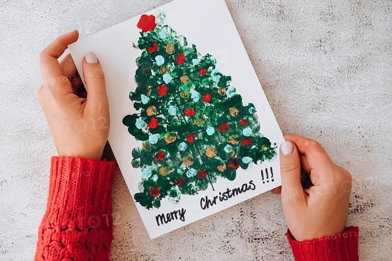 DIY Making greeting card Handmade crafts on holiday for children. Step by step. Do it yourself. Happy New Year xmas tree decoration Paint with fingers Merry Christmas tree. Top view