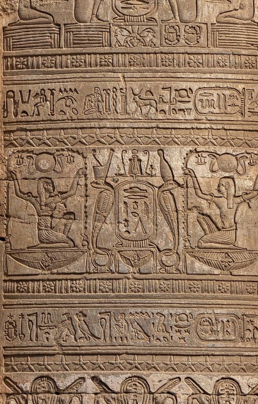 Hieroglyphic carvings on the exterior walls of an ancient egyptian temple