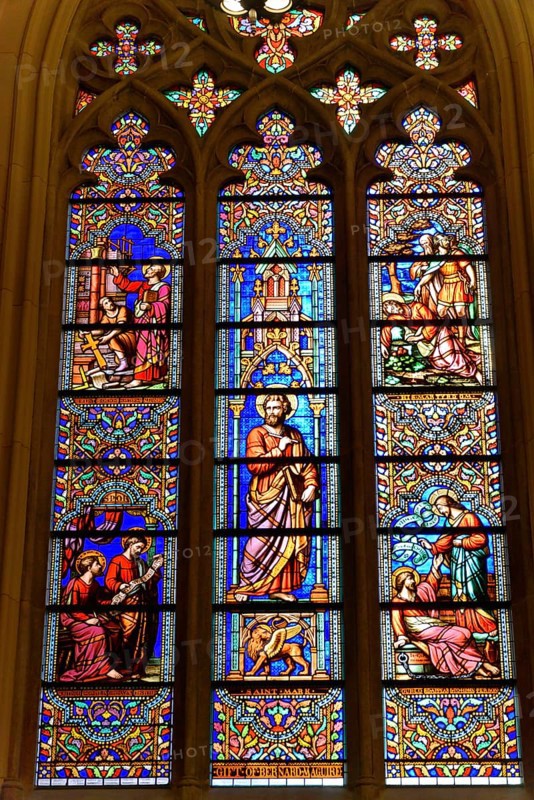 Saint Patricks Old Cathedral or Old St. Patricks, Lower Manhattan, Detailed stained glass window with a biblical depiction in a cathedral, Manhattan, New York City, New York, USA, North America, A stained glass window shows detailed religious scenes and figures in intense colours, North America