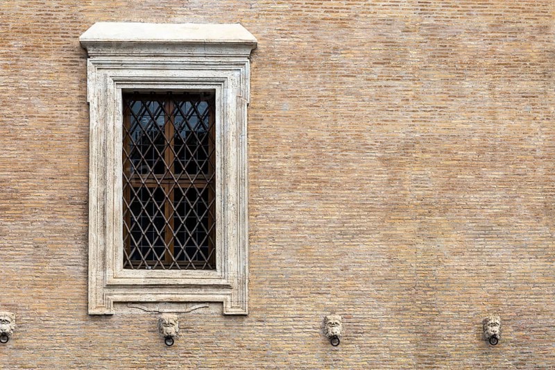 The window with iron gratings on brick wall, for background