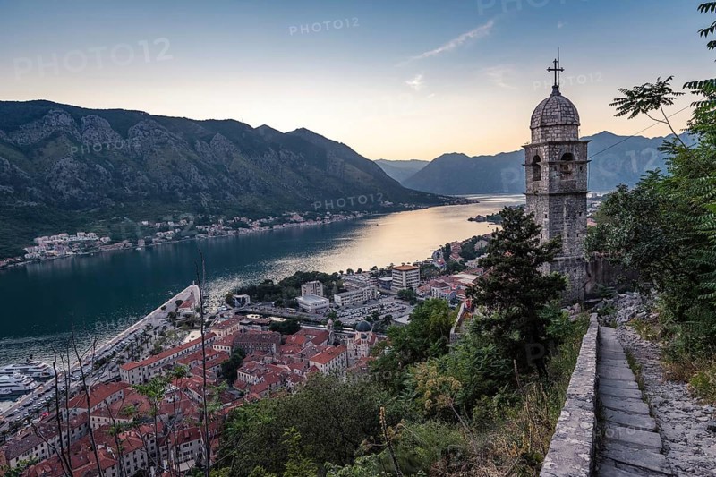 The tower of Church of Our Lady of Remedy and Bay of Kotor view from the hill above the town, Montenegro.