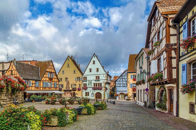 Main square with fountain with statue of pope Leo IX in Eguisheim, Alsace, France, Europe