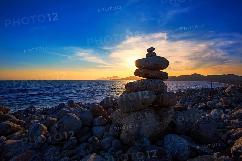 Ibiza Cap des Falco sunset with desire stones at the beach in Sant Josep Balearic Islands