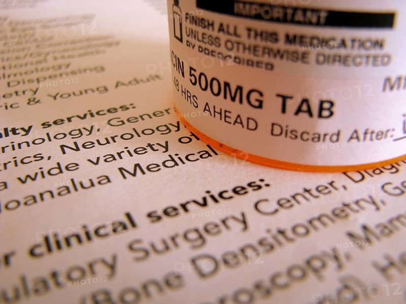 Some prescription medicine on top of some medical documentation