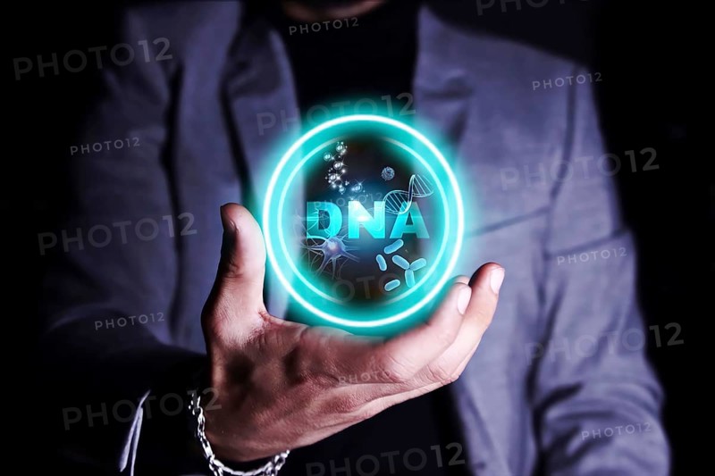 A person holding a holographic display of DNA strands and molecular structures.