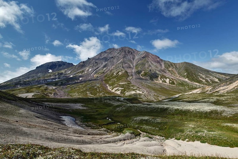 Summer mountain landscape of Kamchatka Peninsula: beautiful view of cone Khangar Volcano on sunny day. Eurasia, Russian Far East