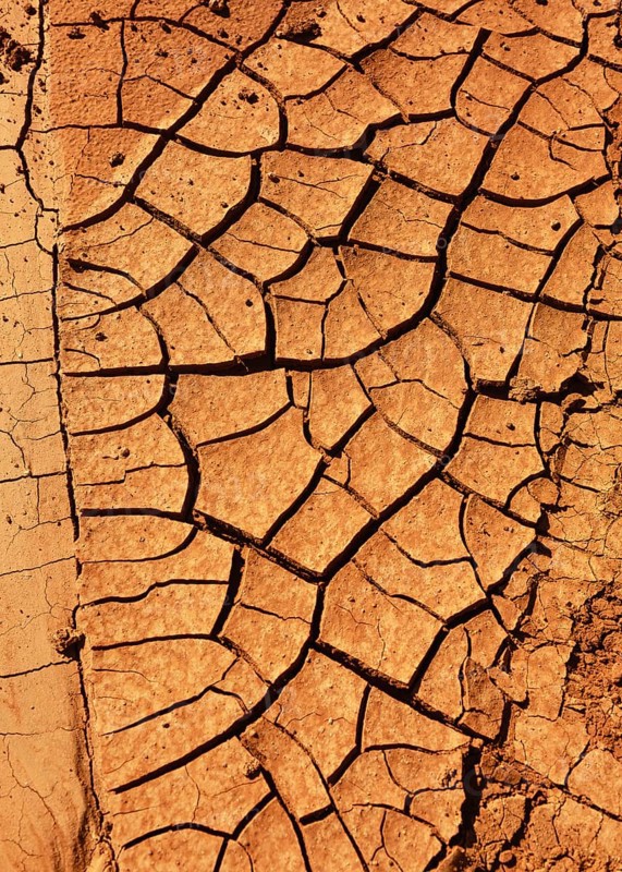 Cracked, dry earth with brown colour tones, reminiscent of arid or desert landscapes. Hiking through Fuerteventura. Canary Islands, Spain, Europe