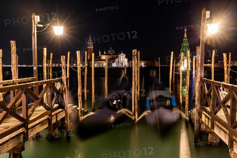 Venetian gondolas, boat dock at St Mark's Square, church of San Giorgio Maggiore in the background, night shot, Venice, Veneto, Italy, Europe