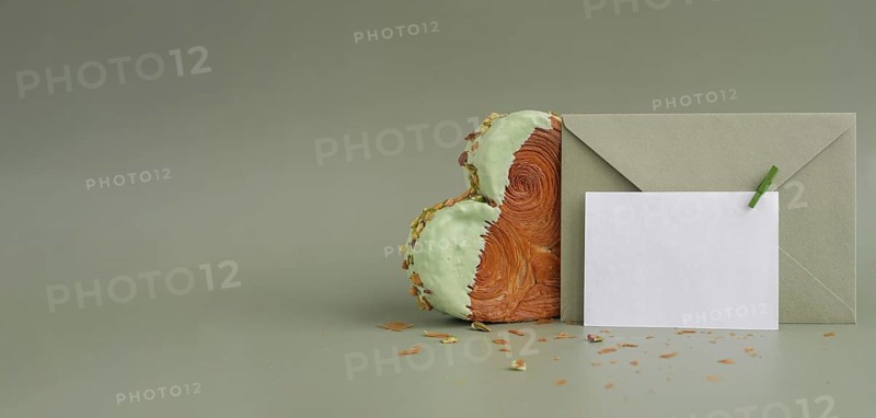 White empty mock up template paper note card Delicious fresh croissant topped with Matcha Green Tea flavor Ganache. Creation unique heart shape bakery. Puff pastry holiday love gift present idea Valentine's day. Copy space