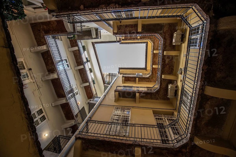 View upwards, inner courtyard of a block of houses. Typical of this type of building in the historic city of Budapest, Hungary, Europe