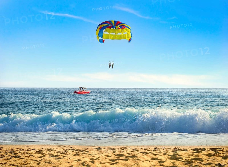 Parasailing over sea in sunny summer day