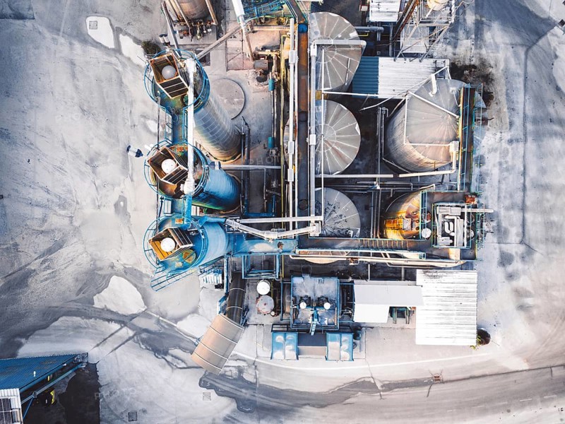 Aerial view of construction firm, asphalt base, whre gravel is being stored for the needs of road repair and other construction highway work