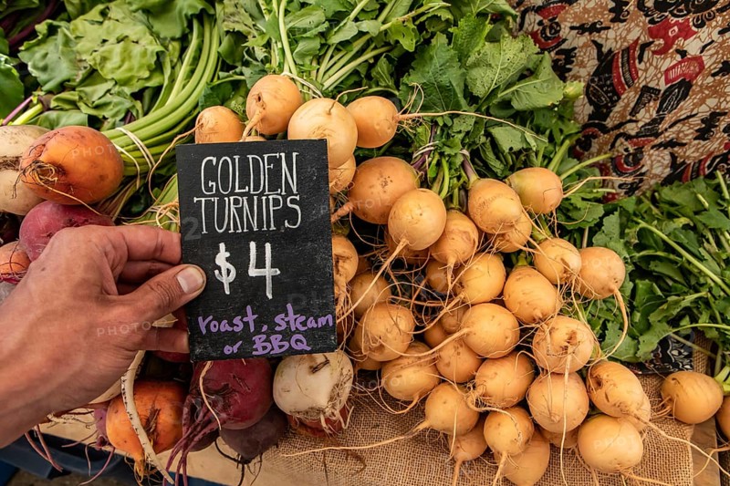 Hand written blackboard sign with the price of golden turnips at the local farmer's market. Real, fresh and genuine food from the countryside, on sale