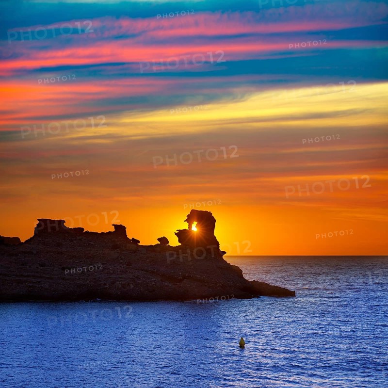 Menorca sunset in Cala Morell at Ses torretes beach Balearic Islands