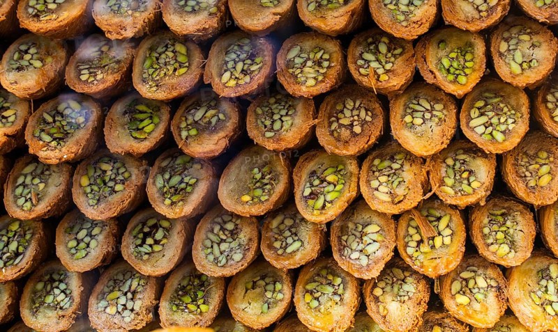 Turkish traditional dessert Kadayif baked in syrup served with nut powder