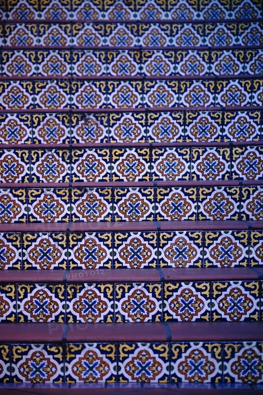 The steps of a staircase decorated with colourful oriental patterned tiles