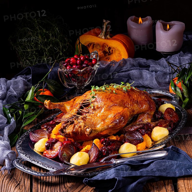Roast duck with potato dumplings and plums