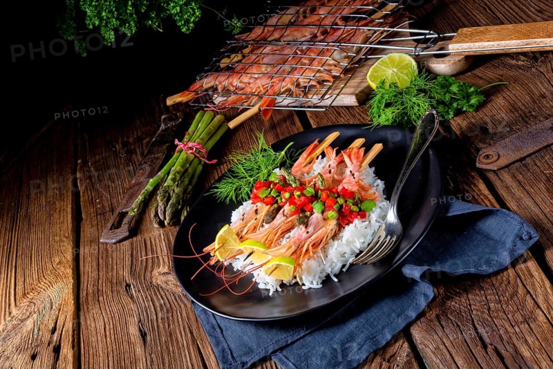 Grilled red argentine shrimps with red salsa and green asparagus