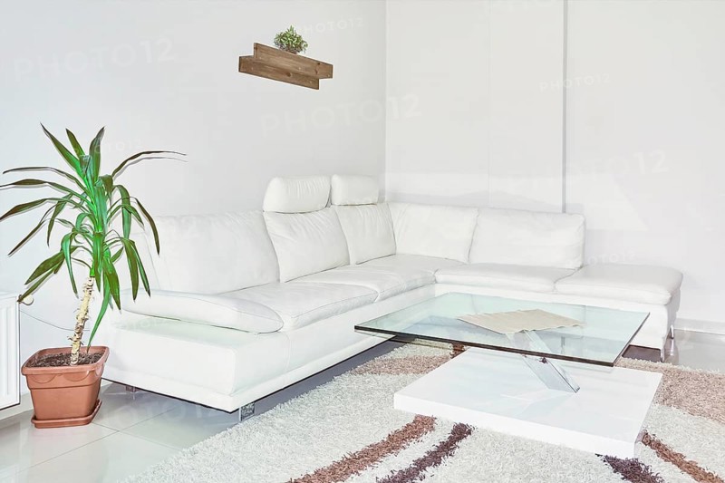 Sofa and Glass Table in the Corner of the Room