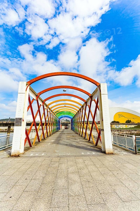 Magnificent light bridge over the river Aviles. The picturesque town of Avilas in Asturias. North of Spain. International cultural center of the famous architect Oscar Niemeyer