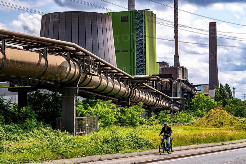 Pipelines for various gases, blast furnace gas, Thyssenkrupp Steel steelworks in Duisburg-Bruckhausen, in front the gas-fired Hamborn power station, green façade of boiler house Block5, North Rhine-Westphalia, Germany