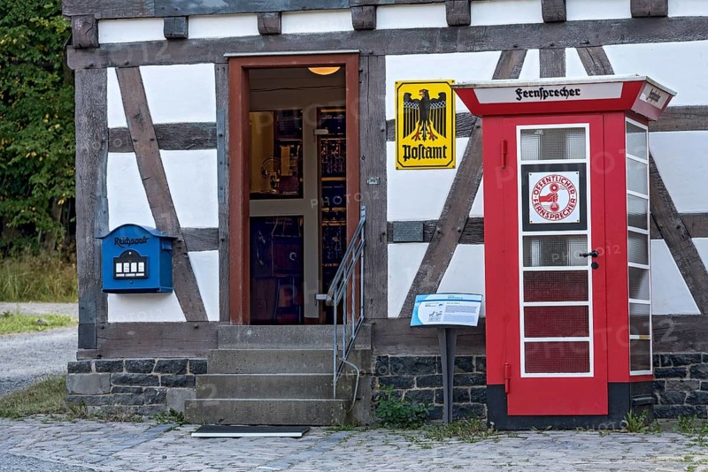 Telephone box, public telephone, historical post office, post office, house from Ahlbach, Hessenpark Open-Air Museum, Neu-Anspach, Taunus, Hesse, Germany