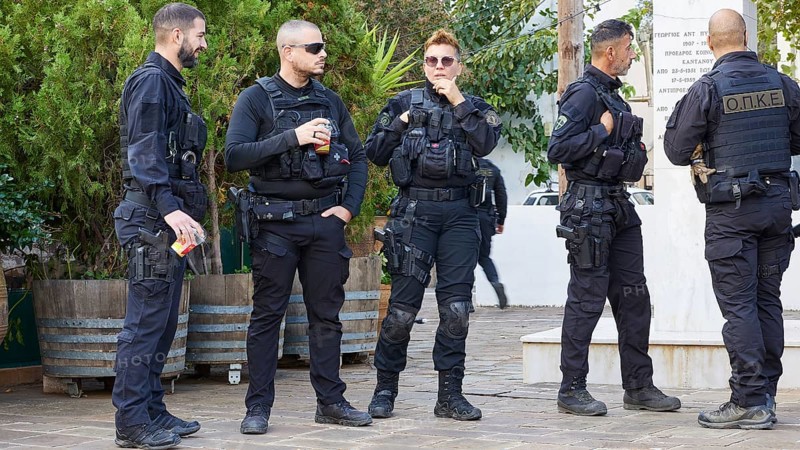 Group of uniformed Greek police officers in riot gear relaxing outdoors, visit of German President Frank-Walter Steinmeier to Kandanos on 31 October 2024, German President, Frank-Walter Steinmeier, memorial, war crimes, Nazis, Wehrmacht crimes, World War II, Kandanos, southwest Crete, Crete, Greek islands, Greece