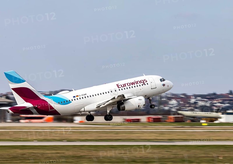 Stuttgart Airport STR EDDS. Manfred Rommel Airport. Eurowings aircraft taking off. Airbus A319-100 with dynamic motion blur. Stuttgart, Baden-Württemberg, Germany