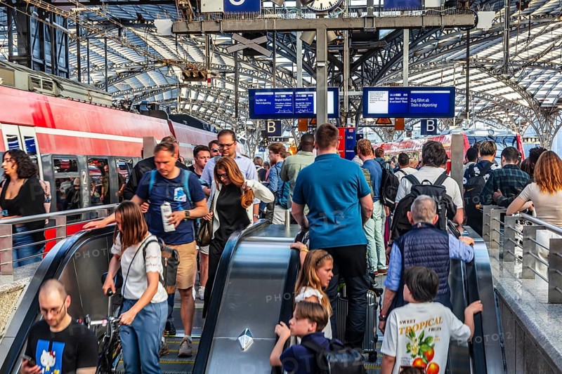 Cologne Central Station. Stairs to the platforms. Travellers waiting for their train on the platform. Crowd with motion blur. Cologne, North Rhine-Westphalia, Germany