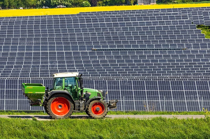Agricultural land is used as a solar field. Tractor. Nellingen in the Swabian Alb. Nellingen, Baden-Württemberg, Germany