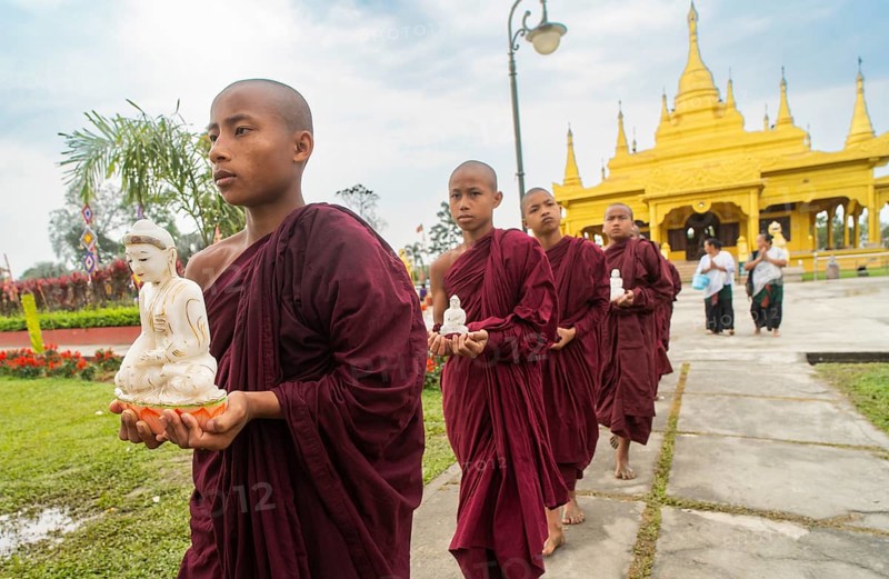 NAMSAI, INDIA.- APRIL 16: Buddhist monks carries the idol of Lord Buddha as they celebrate the vibrant Sangken Festival at Golden Pagoda in Namsai, India on 16 April 2025. Sangken Festival is a beautiful and culturally rich water festival celebrated primarily by the Theravada Buddhist communities, it marks the Buddhist New Year, typically falling in mid-April