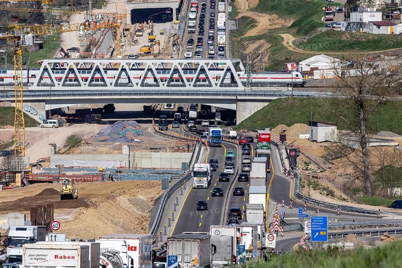 Six-lane widening of the A8 motorway near Pforzheim. Enztal crossing construction site with heavy traffic and congestion. Railway bridge with Deutsche Bahn InterCity IC train. Niefern-Öschelbronn, Baden-Württemberg, Germany