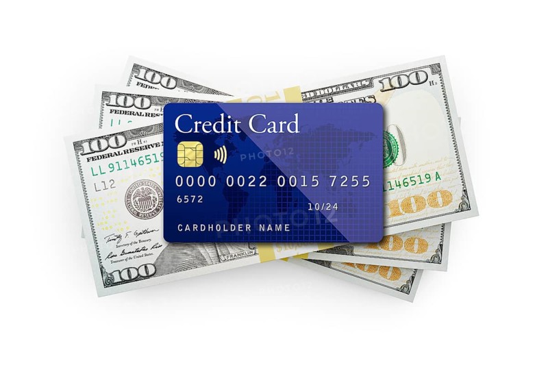 Thirty thousand dollars stack of one hundred dollar bills with a credit card on top isolated on a white background