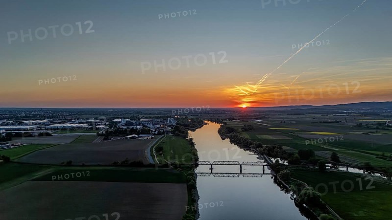 Wide river landscape with railway bridge in the middle, setting sunlight and extensive fields, Danube, Bogen, Lower Bavaria