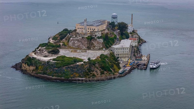 Aerial view of United States Penitentiary, Alcatraz Island, shows a historic maximum-security prison on a small island off San Francisco. Built in 1910-12, it operated from 1934 to 1963 and is now a major tourist attraction