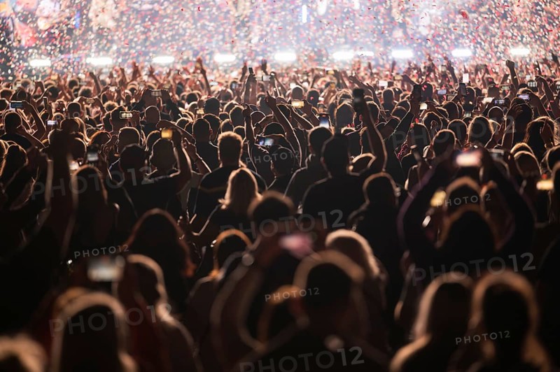 Crowd of people in front of the stage during the concert.