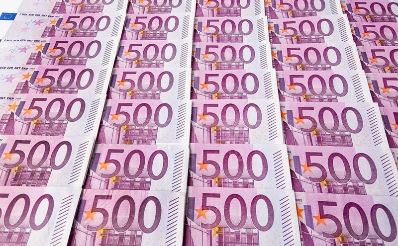 Many five hundred euro banknotes lying next to each other. Symbolic photo for wealth and investment Austria