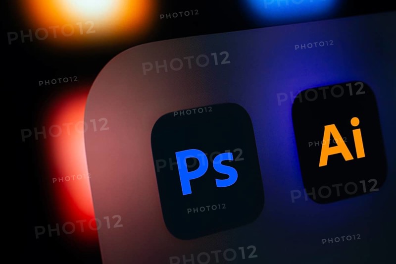 A close up of an iPad screen displaying the Adobe photoshop and adobe illustrator app