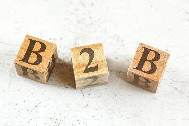 Three wooden cubes with letters B2B - stands for Business to Busines - on white board, Liptovsky Hradok, Slovakia