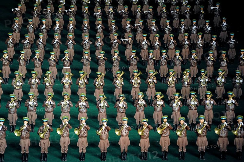 08.08.2012, Pyongyang, North Korea, Asia, A military band performs at the Arirang Festival at the Rungrado May Day Stadium in Pyongyang. The majority of the performances during the mass event are performed by rhythmic gymnastics dancers who have been trained and rehearsed for months in advance. An estimated 100, 000 dancers, acrobats and participants celebrate their patriotism and the socialist unity of the Juche ideology. The event takes place every year in the warm summer months from July to September