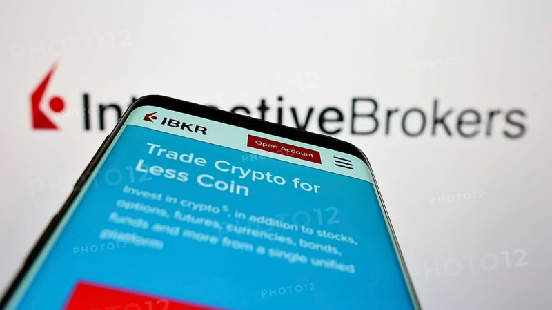 Stuttgart, Germany, 07-24-2022: Smartphone with website of US company Interactive Brokers LLC (IB) on screen in front of business logo. Focus on top-left of phone display