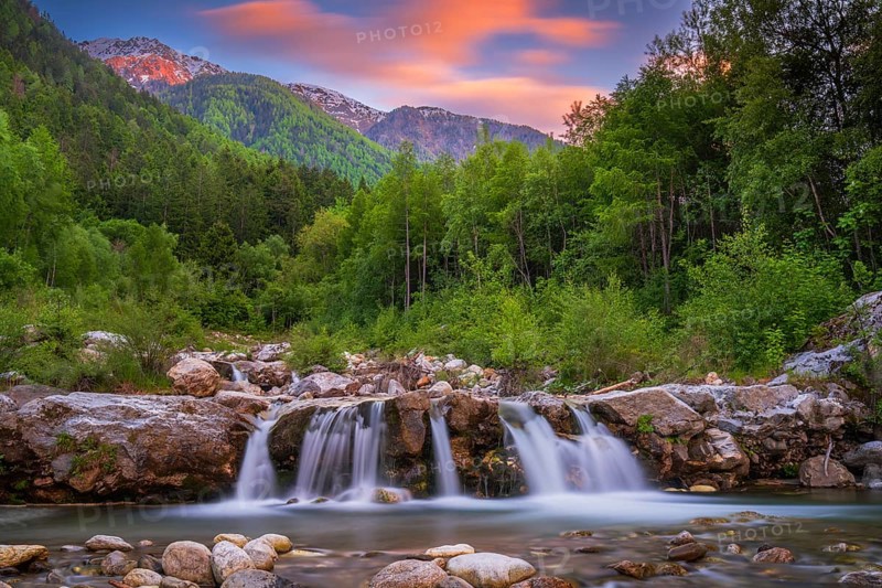 View of a waterfall of the Rio Plima stream in the evening light, long exposure, landscape photo, nature photo, landscape format, forest, trees, Dolomites, South Tyrol, mountains, Laces, Morter, Italy
